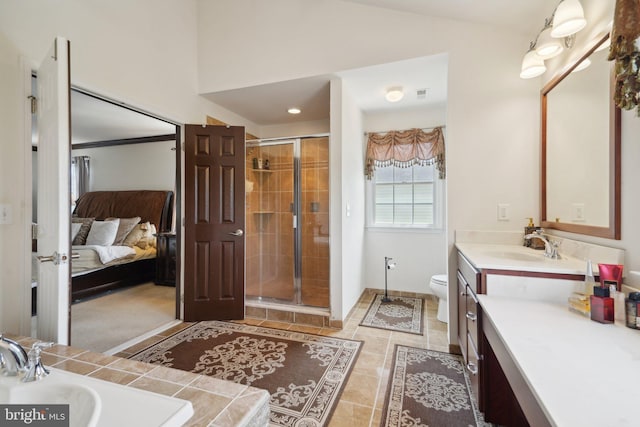 bathroom featuring tile patterned floors, vanity, toilet, and walk in shower