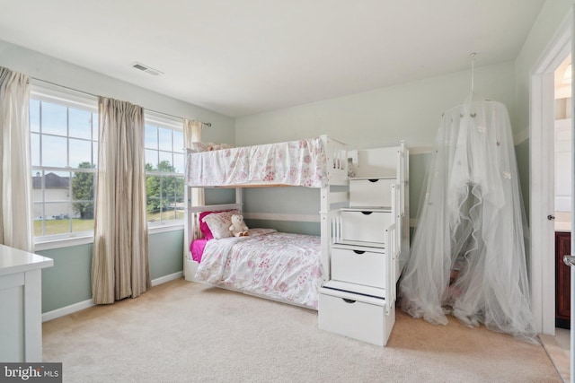 bedroom featuring light colored carpet