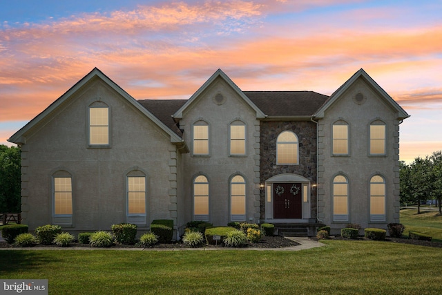 french country inspired facade with a lawn