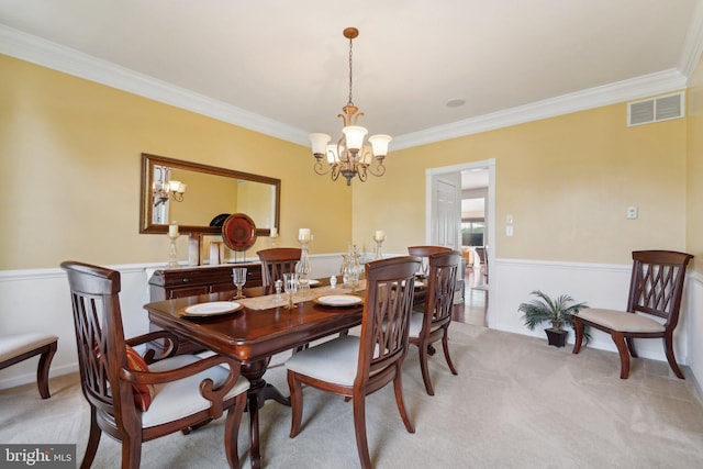 dining space featuring crown molding, light colored carpet, and a notable chandelier