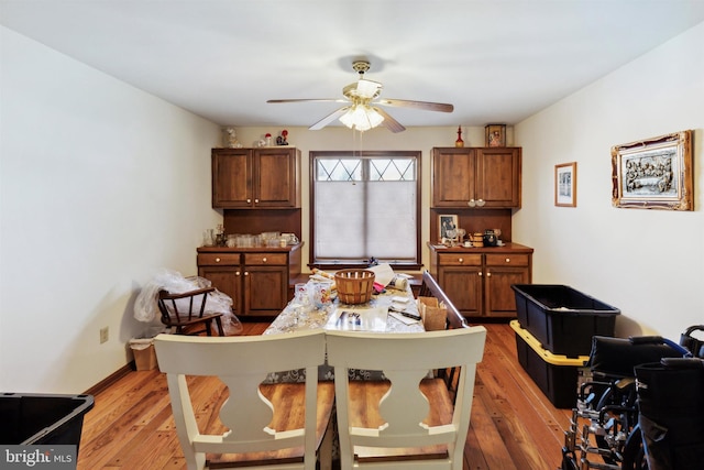 dining space with ceiling fan and light hardwood / wood-style floors