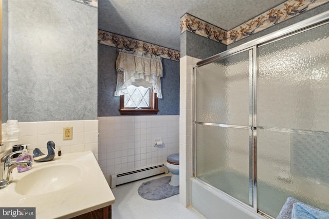 full bathroom with enclosed tub / shower combo, a baseboard heating unit, toilet, vanity, and tile walls