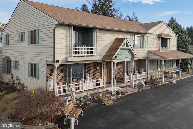 view of front of house featuring a balcony