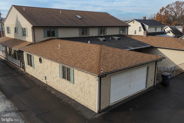 back of property with a garage