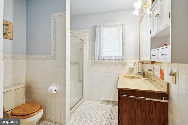 bathroom with toilet, vanity, tile walls, and walk in shower