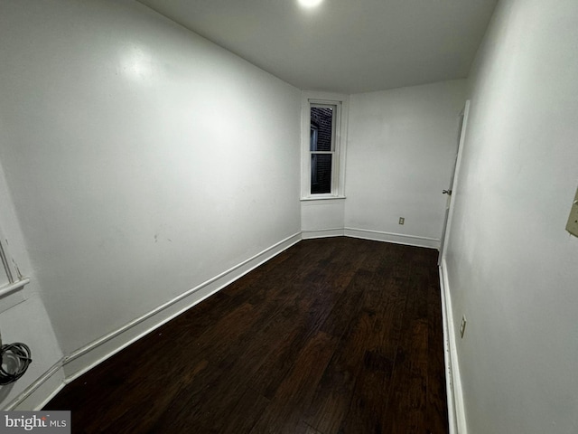 spare room with dark hardwood / wood-style flooring