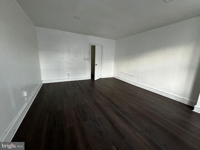 spare room featuring dark hardwood / wood-style floors