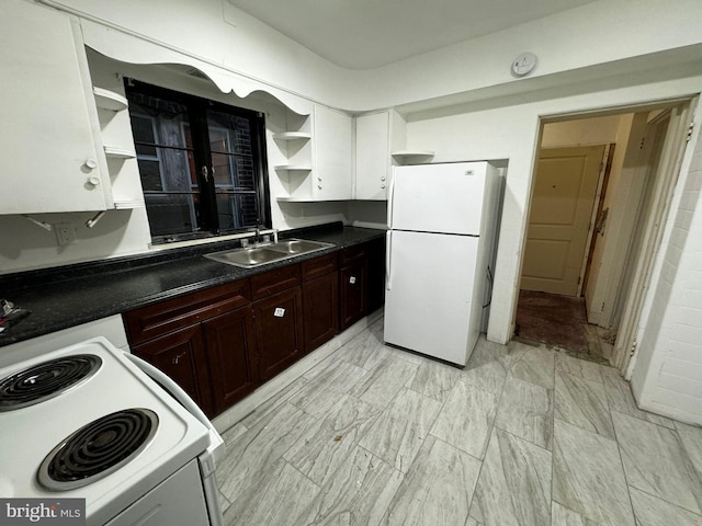 kitchen featuring white cabinetry, sink, and white appliances