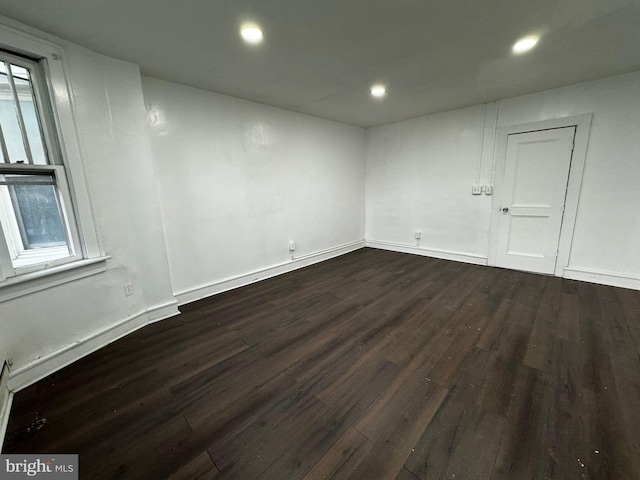 spare room featuring dark hardwood / wood-style flooring