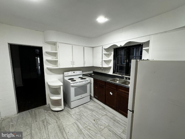 kitchen with white cabinets, white appliances, dark brown cabinetry, and sink