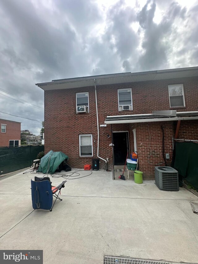 1601 W Venango St, Philadelphia, PA 19140 - back of property with brick siding, a patio, central air condition unit, and cooling unit