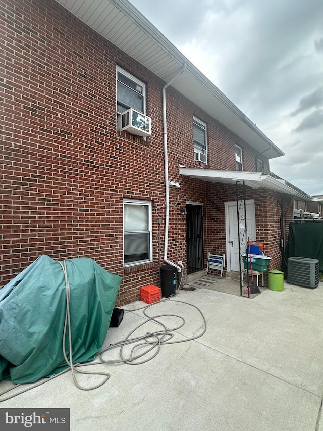 1601 W Venango St, Philadelphia, PA 19140 - back of house with a patio area, brick siding, central air condition unit, and cooling unit