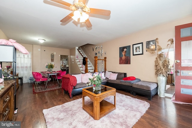 living room with ceiling fan and dark wood-type flooring