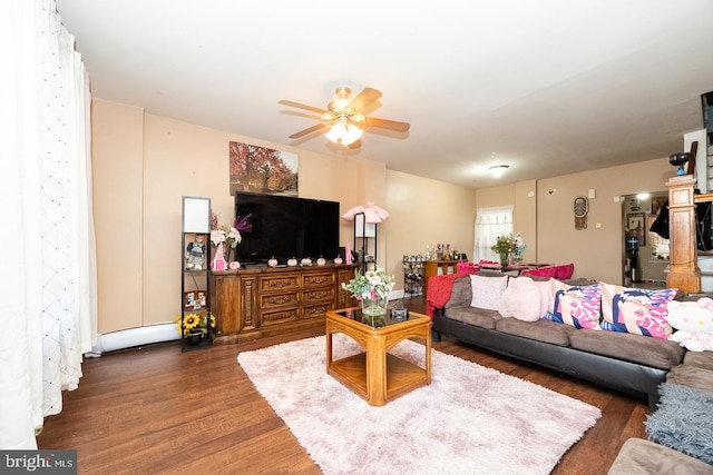 living room featuring dark hardwood / wood-style flooring and ceiling fan