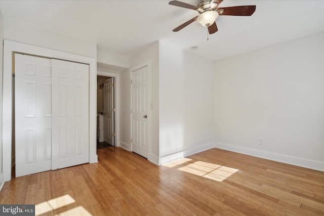 unfurnished bedroom featuring a closet, light hardwood / wood-style flooring, and ceiling fan