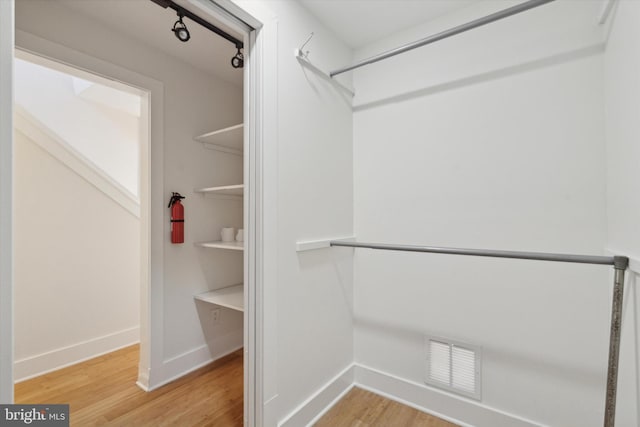 spacious closet with hardwood / wood-style flooring