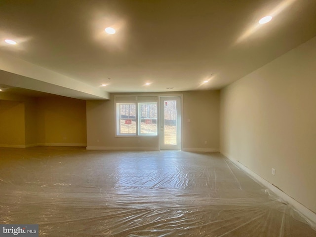 unfurnished room with recessed lighting and baseboards