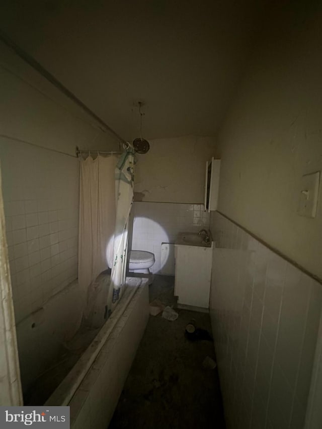 full bathroom featuring tile walls, vanity, shower / tub combo, and toilet