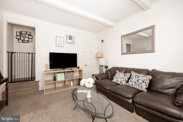 living room with beamed ceiling and carpet flooring