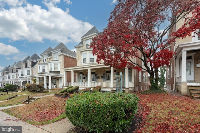 view of property featuring covered porch