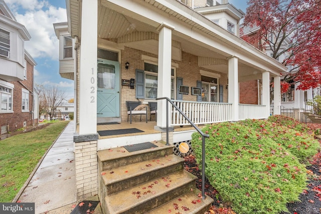 view of exterior entry with covered porch