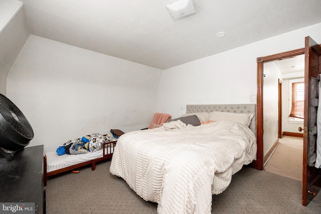 carpeted bedroom featuring lofted ceiling