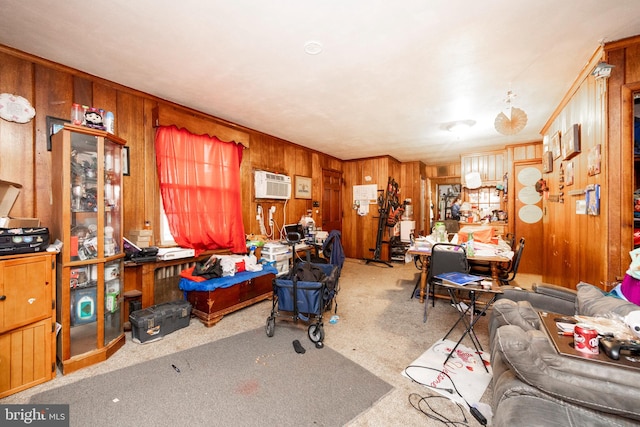 office space with a wall mounted air conditioner, wood walls, and light carpet