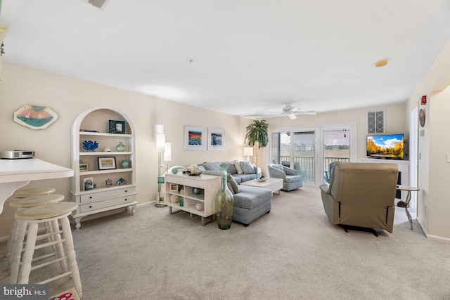 living room featuring ceiling fan and light colored carpet