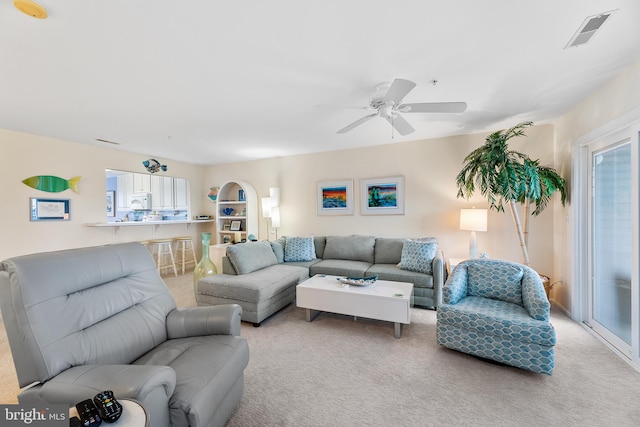 carpeted living room featuring ceiling fan