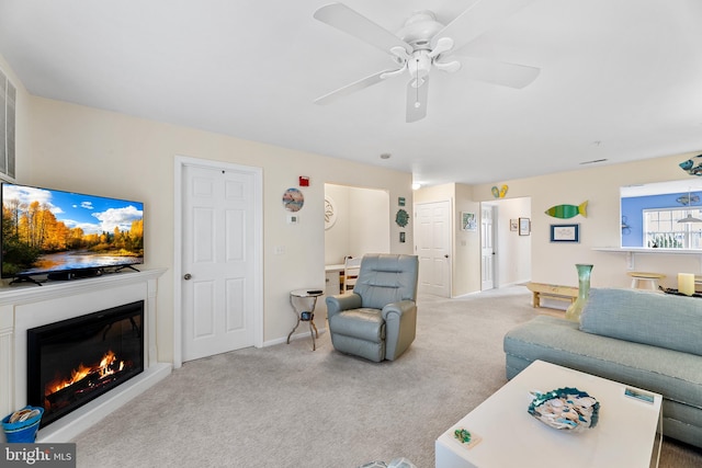 carpeted living room featuring ceiling fan