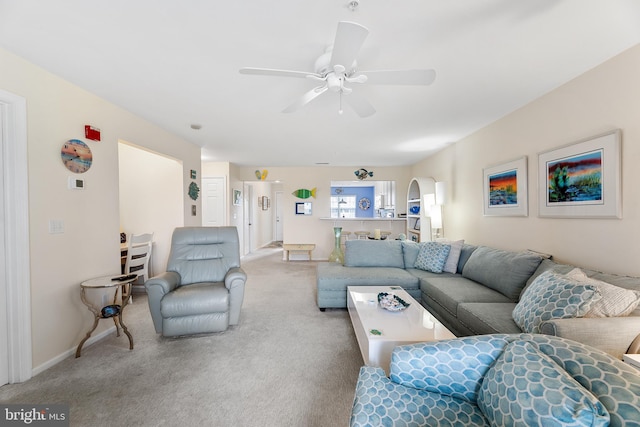 carpeted living room with ceiling fan