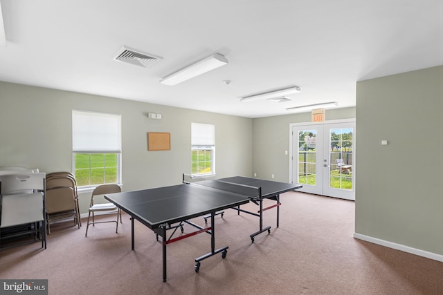 game room featuring french doors, light colored carpet, and a healthy amount of sunlight