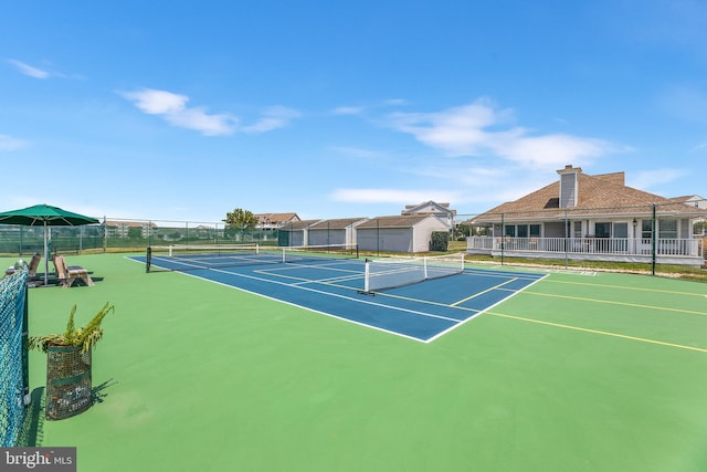 view of tennis court with basketball hoop