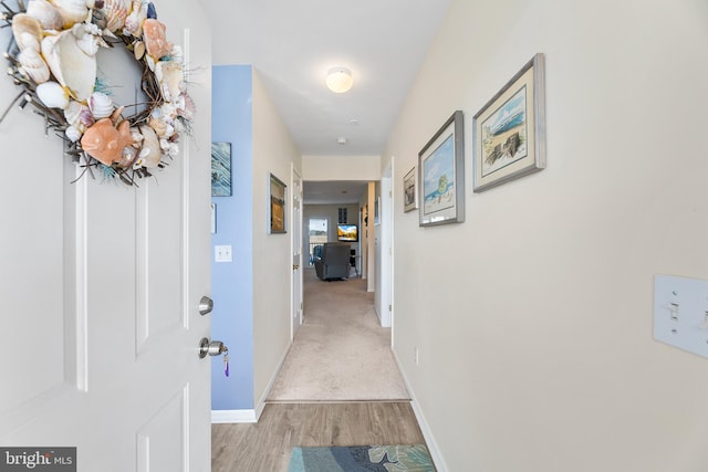 hall with light hardwood / wood-style flooring