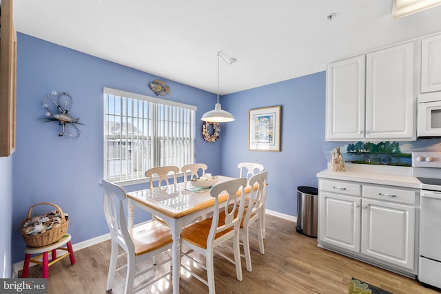 dining space with light hardwood / wood-style floors