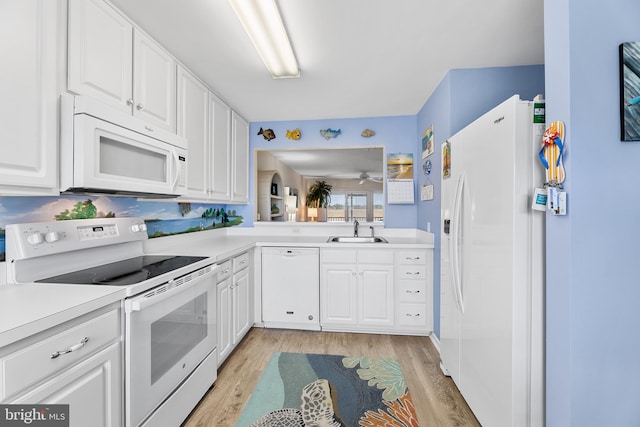 kitchen featuring sink, white cabinets, white appliances, and light hardwood / wood-style flooring