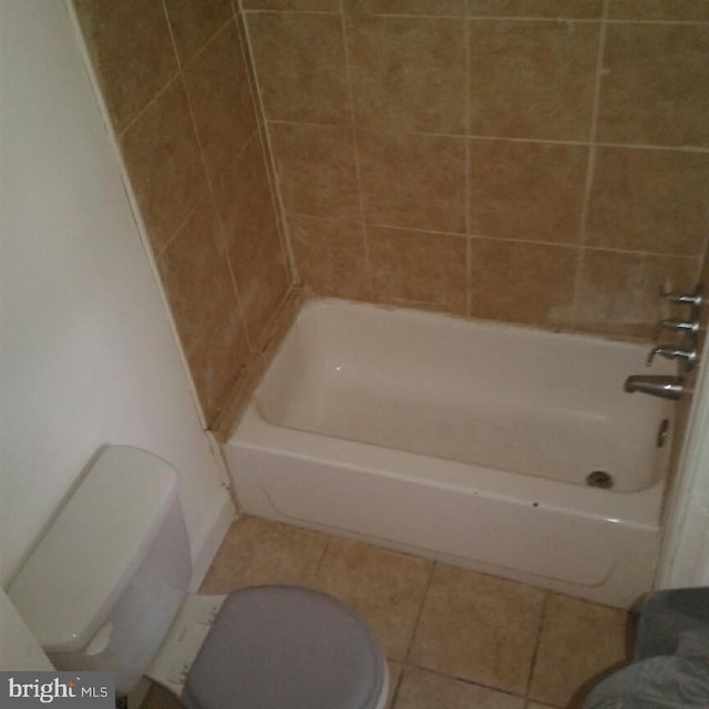 bathroom with shower / tub combination, tile patterned flooring, and toilet