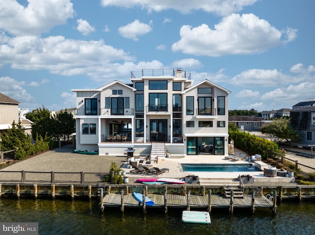 back of house featuring a patio area and a water view