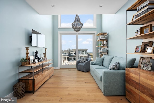 sitting room with light hardwood / wood-style flooring and a chandelier