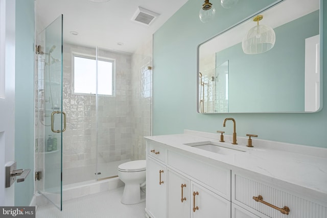 bathroom featuring tile patterned floors, vanity, toilet, and walk in shower