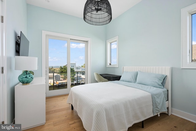 bedroom with light wood-type flooring and access to outside