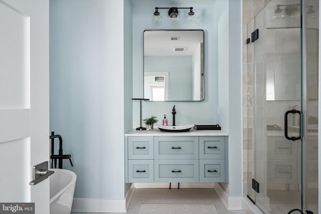 bathroom with tile patterned flooring, shower with separate bathtub, and vanity