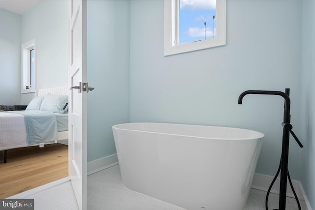 bathroom featuring a washtub and hardwood / wood-style flooring