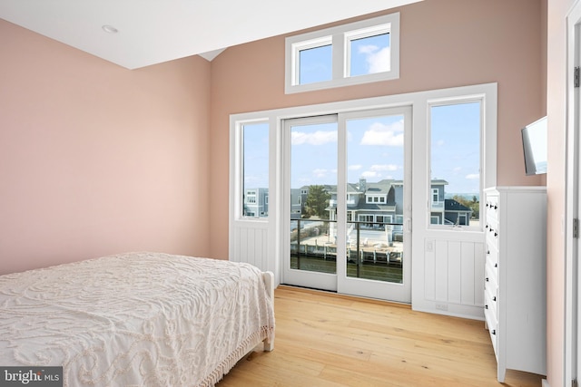 bedroom with access to exterior and light hardwood / wood-style flooring