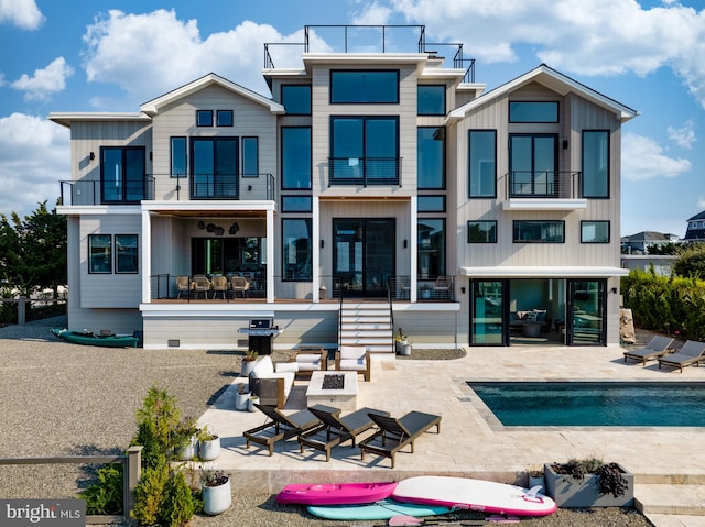 back of house with a patio area and a balcony