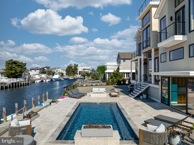 view of pool featuring a water view and a patio area