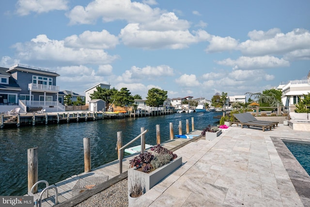 dock area featuring a patio and a water view