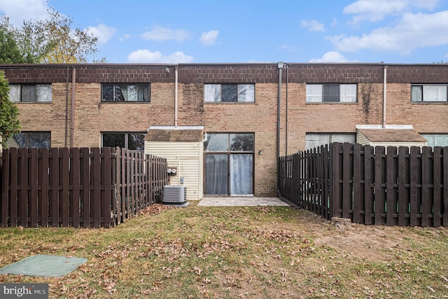 back of house with central AC unit