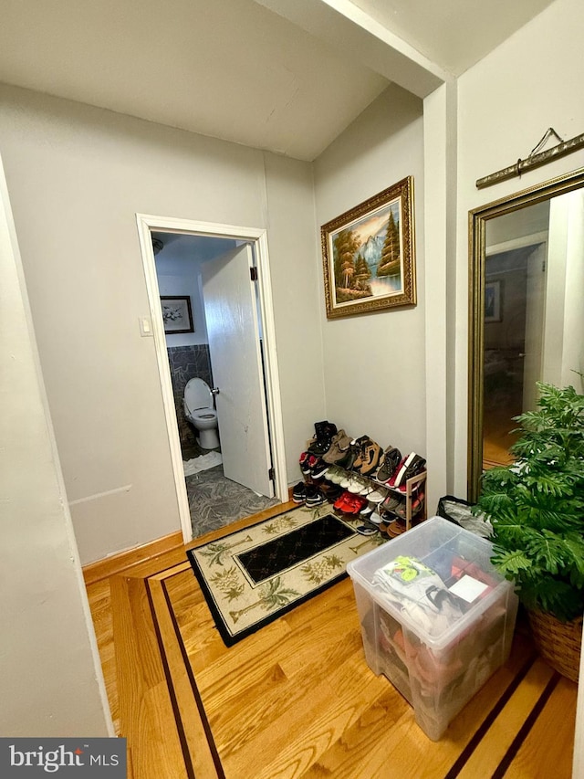 hall with hardwood / wood-style floors