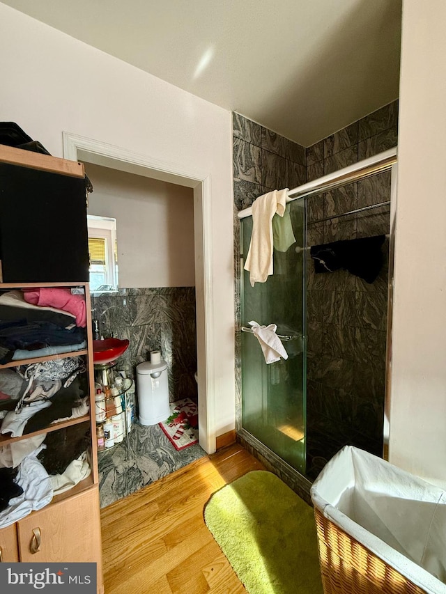 bathroom with walk in shower and hardwood / wood-style flooring